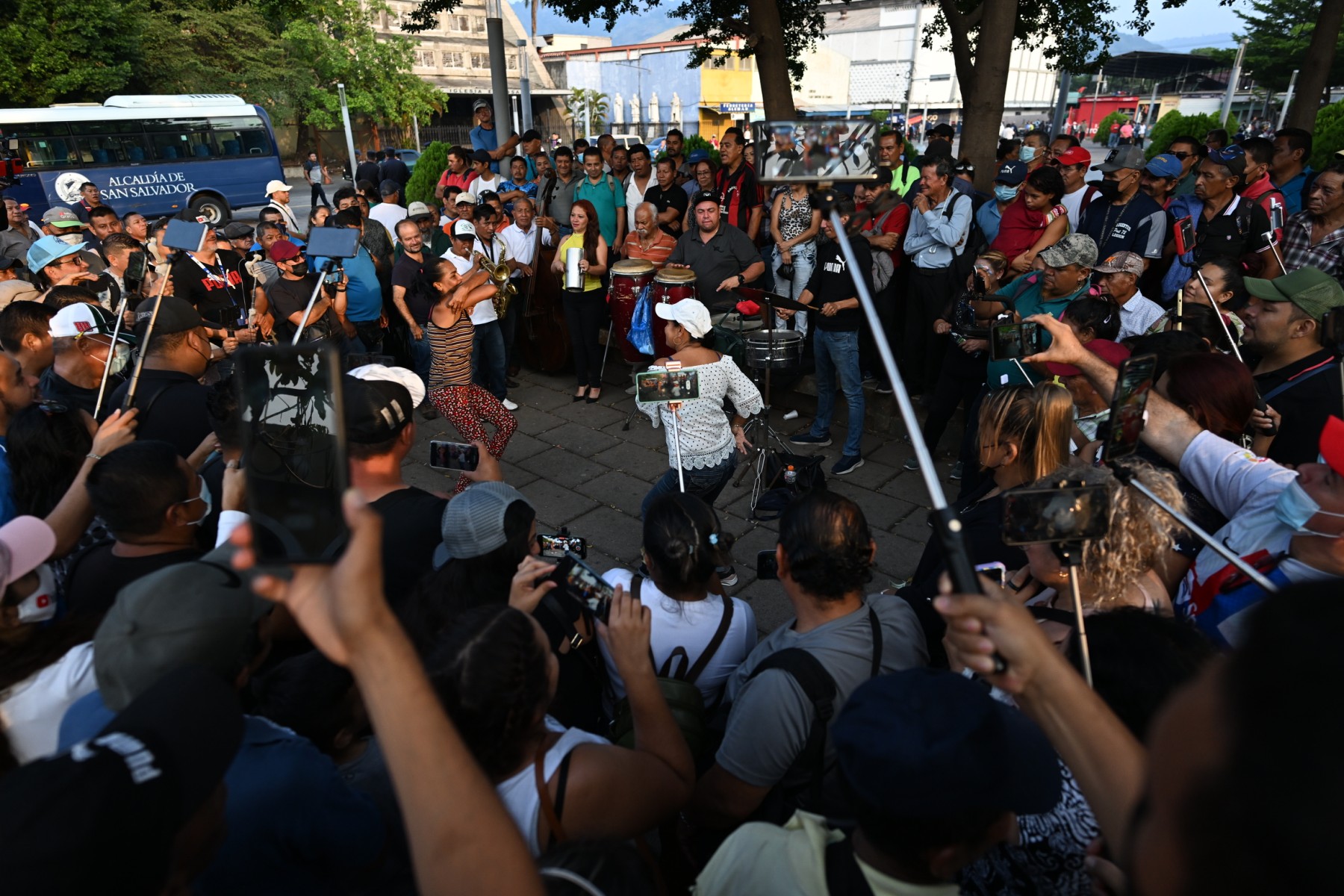 People have fun dancing and playing music in Plaza Libertad at the historic center of San Salvador on May 12, 2023. - The "war" against gangs, launched 14 months ago by President Nayib Bukele, has created a safe environment in the country, encouraging people to occupy public spaces. 