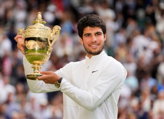 Carlos Alcaraz alza el trofeo de campeón de Wimbledon tras derrotar a Novak Djokovic.