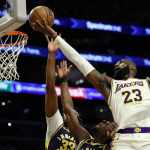 El alero de los Lakers de Los Ángeles LeBron James lanza el balón sobre el pívot de los Pacers de Indiana Myles Turner y el alero Aaron Nesmith en el encuentro del domingo 24 de marzo del 2024. Foto: Etienne Laurent-AP/La Hora