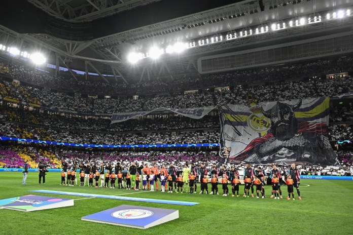 Los seguidores del Real Madrid despliegan una pancarta gigante antes del partido de ida de los cuartos de final de la Liga de Campeones de la UEFA entre el Real Madrid CF y el Manchester City en el estadio Santiago Bernabeu de Madrid el 9 de abril de 2024. (Foto de JAVIER SORIANO / AFP)