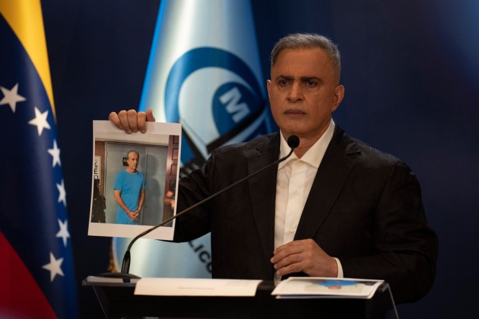 Venezuelan Attorney General Tarek William Saab shows a photograph of Tareck El Aissami, a former oil minister who is under arrest, during a press conference on Monday, April 29, 2024, in Caracas, Venezuela.  (AP Photo/Ariana Cubillos)