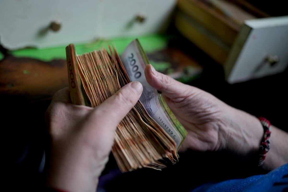 Un trabajador cuenta el dinero en una tienda de abarrotes en Buenos Aires, Argentina, 21 de noviembre de 2023. (AP Foto/Natacha Pisarenko, Archivo)