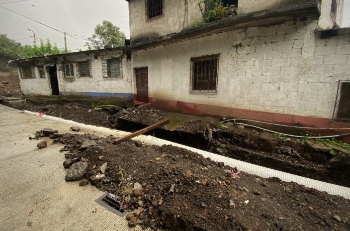 Los habitantes de las casas a orillas de la "carretera" han tenido que poner tablas para poder acceder a sus casas. Foto: La Hora / José Orozco. 