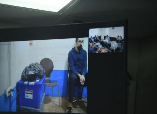 Kevin Malouf sigue presentándose a la audiencia vía videoconferencia, mientras que el resto de sindicados son trasladados a la sala de audiencias. Foto: Fabricio Alonzo.