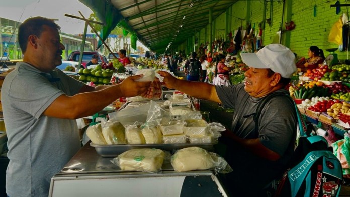 Vendedores ofrecen sus productos mientras compradores destacan la existencia de un alza en el costo de alimentos de la canasta básica. Foto Daniel Ramírez