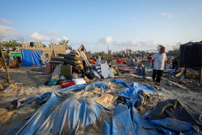 Palestinos observan la destrucción causada por un ataque israelí contra un atestado campo de refugiados palestinos, en Muwasi, Gaza, el 10 de septiembre de 2024. (AP Foto/Abdel Kareem Hana)