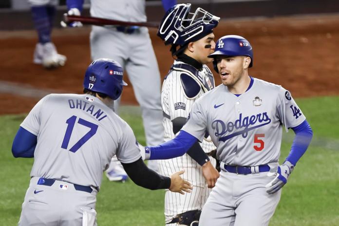 New York (United States), 28/10/2024.- Dodgers Freddie Freeman (R) celebrates hitting a two run home run with teammate Shohei Ohtani (L) during the first inning of game three of the Major League Baseball (MLB) World Series between the American League Champion New York Yankees and the National League Champion Los Angeles Dodgers at Yankees Stadium in the Bronx borough of New York, New York, USA, 28 October 2024. The World Series is the best-of-seven games. (Nueva York) EFE/EPA/CJ GUNTHER