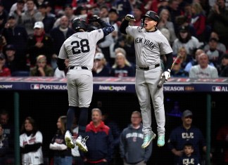 New York Yankees' Austin Wells (28) celebrates with Alex Verdugo after hitting a home run against the Cleveland Guardians during the second inning in Game 4 of the baseball AL Championship Series Friday, Oct. 18, 2024, in Cleveland. (AP Photo/Sue Ogrocki)