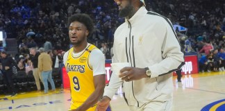 El escolta de los Lakers de Los Ángeles, Bronny James (9), sale de la cancha con LeBron James durante el medio tiempo de un partido de baloncesto de pretemporada de la NBA contra los Warriors de Golden State en San Francisco, el viernes 18 de octubre de 2024. (AP Foto/Jeff Chiu)