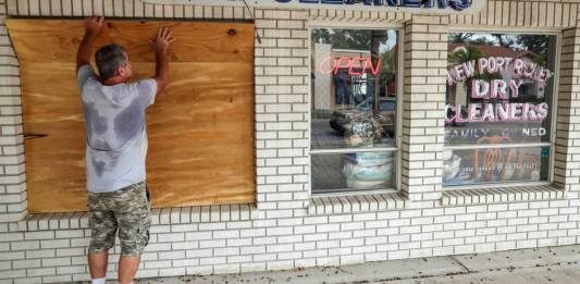 Cubren las ventanas de negocio ante la llegada del huracán Milton. (AP Foto/Mike Carlson)