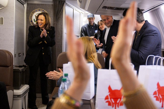 La candidata presidencial demócrata a la vicepresidenta Kamala Harris, a la izquierda, y su personal aplauden mientras se felicitan mutuamente por el final de la campaña, el martes 5 de noviembre de 2024, a bordo del Air Force Two en su regreso a Washington, después de la finalización del último mitin de campaña de Harris, en Filadelfia. Con ella están Nik Ajagu, desde la segunda a la izquierda, la sobrina de Harris, Meena Harris, y el segundo caballero Doug Emhoff. (Foto AP/Jacquelyn Martin, Pool)