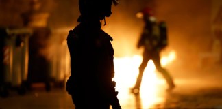 Un agente de la policía Nacional en la plaza de Virgen, en Valencia, tras la manifestación en la que cerca de 40 organizaciones sociales, cívicas y sindicatos de izquierda de la Comunitat Valenciana han marchado este sábado en protesta por la gestión de la dana y con el lema "Mazón dimisión", en alusión al president de la Generalitat. EFE/Jorge Zapata