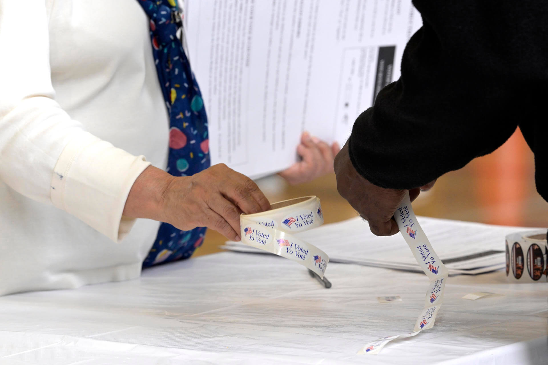 Una voluntaria entrega una pegatina que dice 'Yo he votado'. Foto La Hora EFELenin Nolly