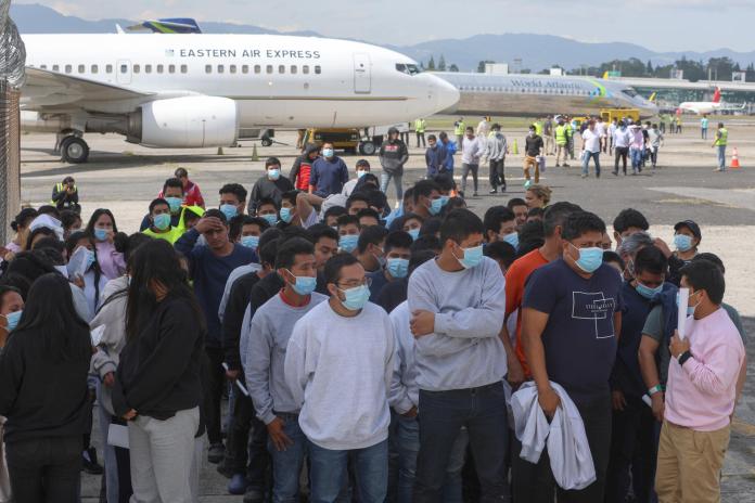 Migrantes que hacen parte de 56 unidades familiares, caminan al ser retornados este viernes a Ciudad de Guatemala. Foto La Hora: EFE