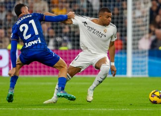 El delantero francés del Real Madrid Kylian Mbappé (d), pelea un balón con el defensa del Getafe, Juan Iglesias, en el partido de LaLiga este domingo en el estadio Santiago Bernabéu. Foto La Hora: EFE/ Sergio Pérez