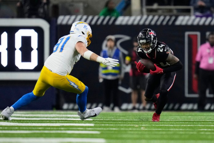 El cornerback de los Houston Texans, Derek Stingley Jr. (24), intercepta un pase frente al ala cerrada de los Los Angeles Chargers, Will Dissly (81), durante la segunda mitad de un partido de comodines de la NFL el sábado 11 de enero de 2025 en Houston. Foto La Hora: AP