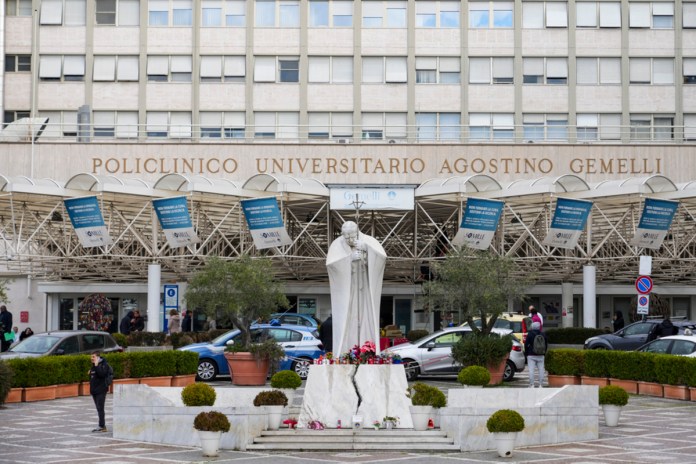 Una escultura del papa Juan Pablo II se yergue ante la Policlínica Agostino Gemelli, donde está hospitalizado el papa Francisco, el lunes 17 de febrero de 2025, en Roma. Foto La Hora: AP