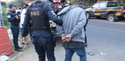 Agentes de la comisaría 14 capturando a dos presuntos asaltantes en la zona 7. Foto La Hora: PNC