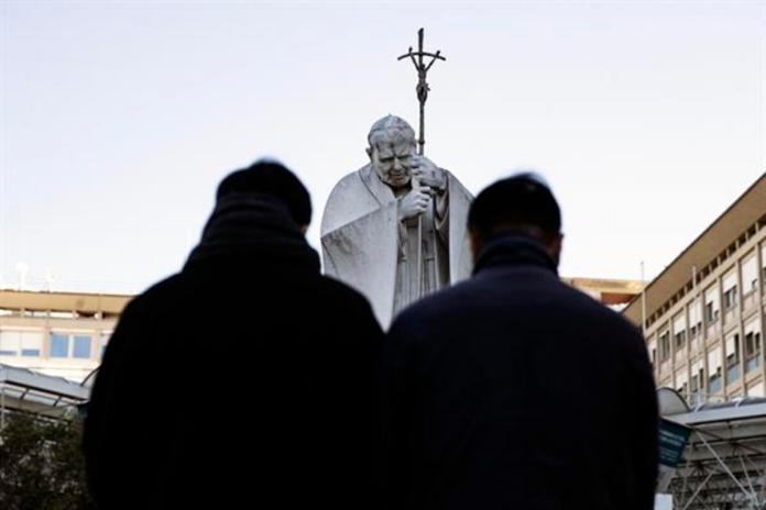 Fieles rezan frente a la estatua de Juan Pablo II en la entrada del Hospital Gemelli, donde está hospitalizado el Papa Francisco, en Roma, Italia, 05 de marzo de 2025. Foto La Hora: EFE