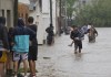 Varias personas caminan en medio de una inundación debido a fuertes lluvias este viernes, en Bahía Blanca (Argentina). Foto La Hora: EFE