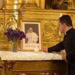 El sacerdote Luis René Sandoval Quinteros se encuentra frente a una fotografía del papa Francisco.