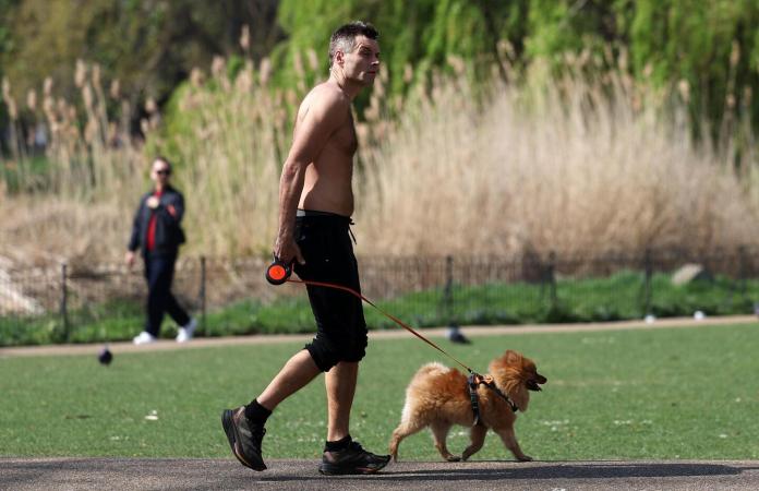 Un hombre paseando a su perro en Londres. Foto La Hora: EFE