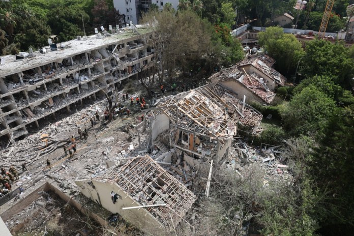 Irán responde a EEUU con más misiles en Israel: Equipos de emergencia israelíes trabajan en el lugar del ataque con misiles iraníes contra un complejo residencial en Tel Aviv, Israel. Foto: EFE-Abir Sultan.