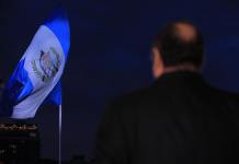 La bandera nacional de Guatemala y el expresidente Alejandro Giammattei, en 2022. Foto La Hora: Facebook del expresidente.