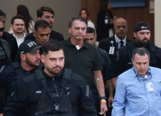 El expresidente Jair Bolsonaro, en el centro, al que se le permitió salir temporalmente del arresto domiciliario para recibir tratamiento médico, sale de un hospital en Brasilia, Brasil, el domingo 14 de septiembre de 2025. (AP Foto/Luis Nova)