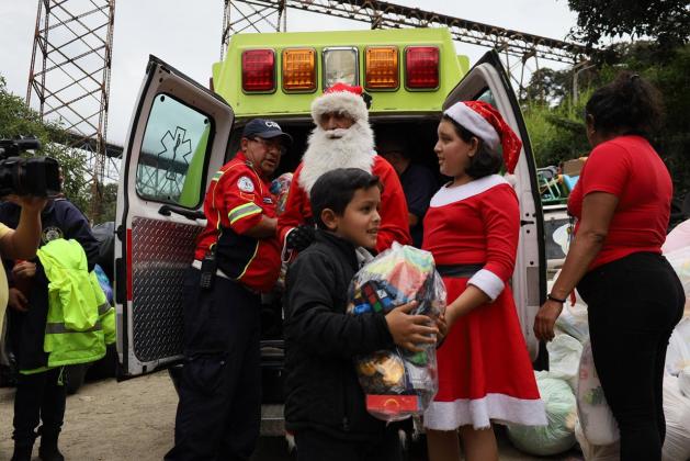 Desde hace 28 a&ntilde;os, el Mayor de los Bomberos Municipales, H&eacute;ctor Chac&oacute;n, ha descendido del puente Las Vacas para llegar juegues a ni&ntilde;os de tres asentamientos del lugar. Foto La Hora: Daniel Ram&iacute;rez