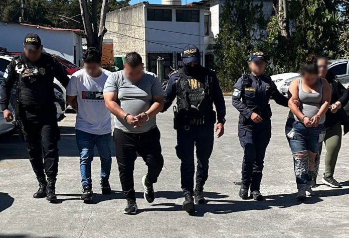 Dos hombres y dos mujeres fueron capturados en la zona 19 de la colonia Florida por la PNC. Las autoridades les incautaron dos escopetas y una pistola. Foto La Hora: PNC