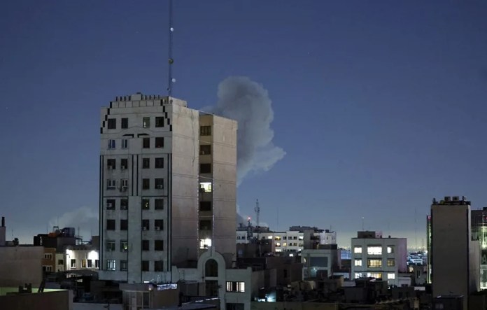 EPA6890-IRAN-ISRAEL-USA-ATTACK El humo se eleva detrás de un edificio tras una explosión en el segundo día consecutivo de ataques por parte de Estados Unidos e Israel, en Teherán, Irán. EFE/EPA/ABEDIN TAHERKENAREH