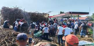 Personas ayudan a bomberos para rescartar a heridos por el camión que volcó en Tiquisate. Foto: Bomberos Voluntarios