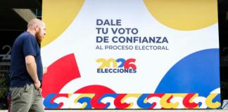 AME6869. BOGOTÁ (COLOMBIA), 30/05/2026.- Una persona camina frente a un cartel alusivo a las elecciones presidenciales de 2026 en el recinto ferial de Corferias este sábado, en Bogotá (Colombia). Las autoridades colombianas ultiman los preparativos para la primera vuelta de las elecciones presidenciales de este domingo para las que están habilitados 41.421.973 ciudadanos que podrán votar para elegir al sucesor de Gustavo Petro, el actual mandatario, quien no puede presentarse a la reelección porque no lo permite la Constitución. Foto: La Hora/ EFE/ Carlos Ortega